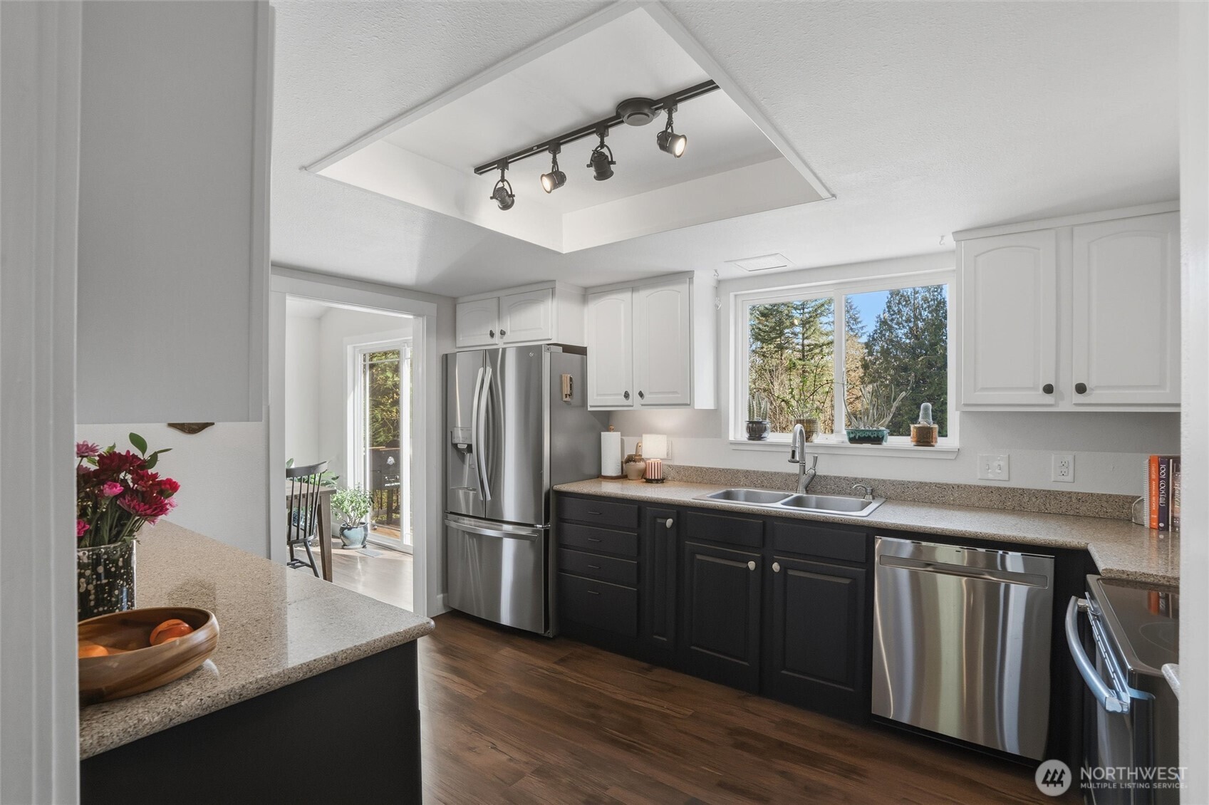 2065 Opdal Road East Port Orchard, WA 98366 - Photo 19 of 40 a kitchen with stainless steel appliances granite countertop a sink dishwasher and a refrigerator with wooden floor