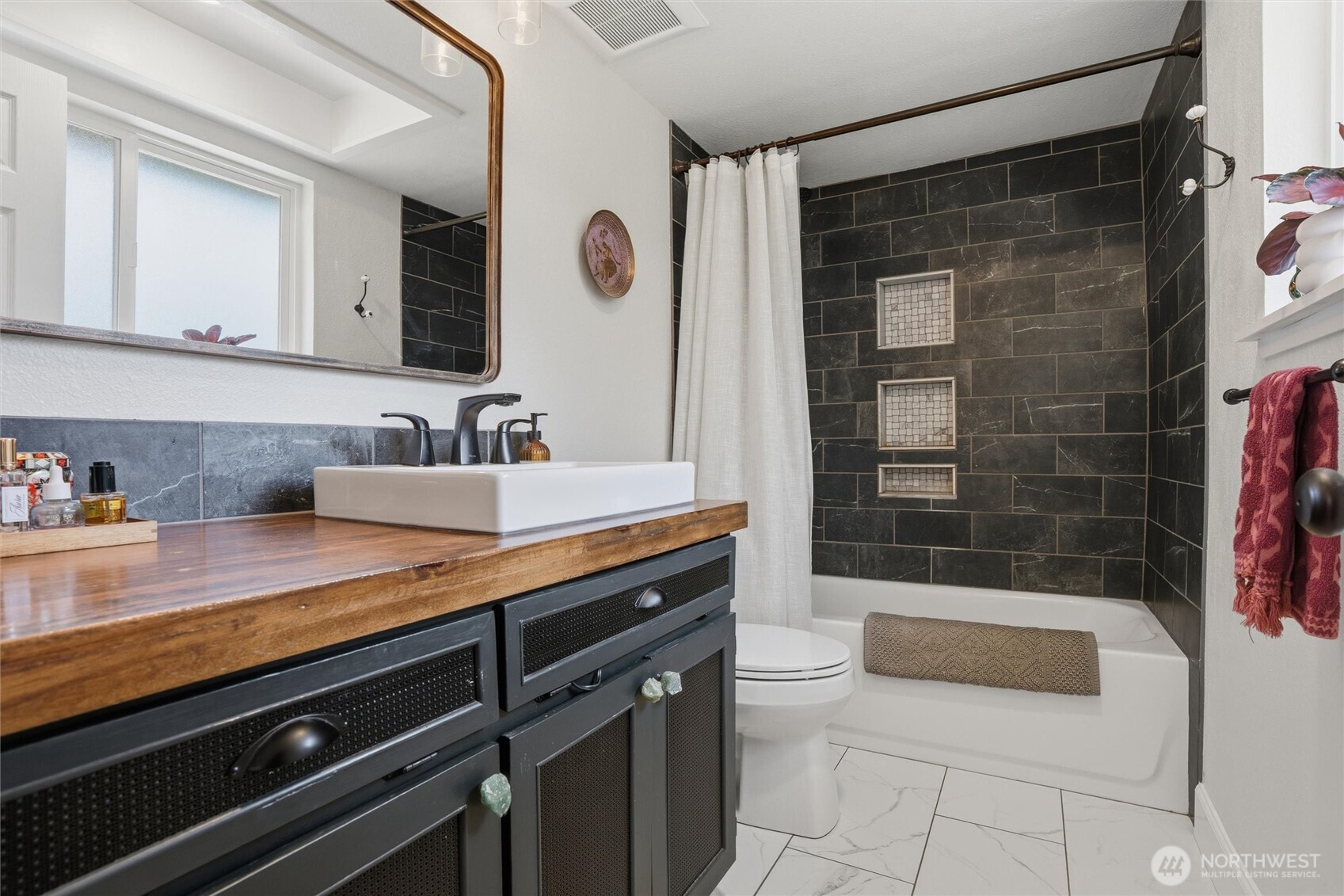2065 Opdal Road East Port Orchard, WA 98366 - Photo 27 of 40 a spacious bathroom with a granite countertop sink a mirror and shower