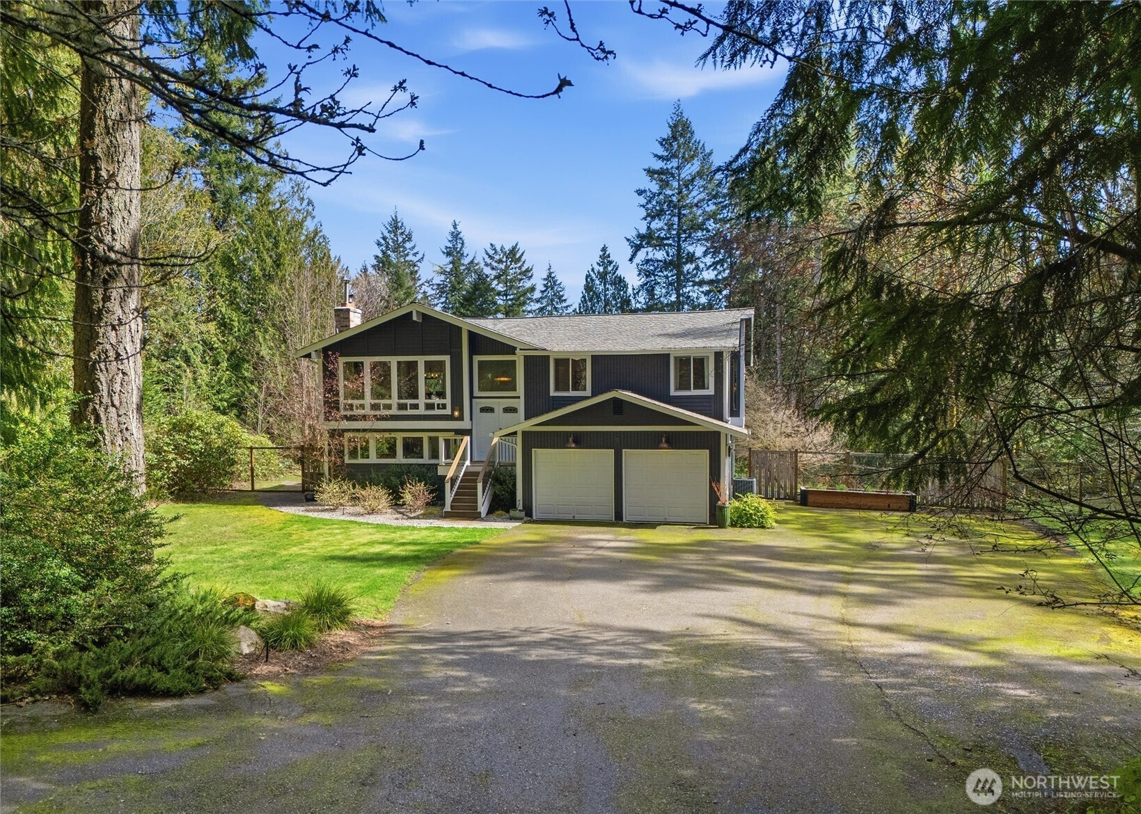 2065 Opdal Road East Port Orchard, WA 98366 - Photo 3 of 40 a front view of a house with a garden and trees
