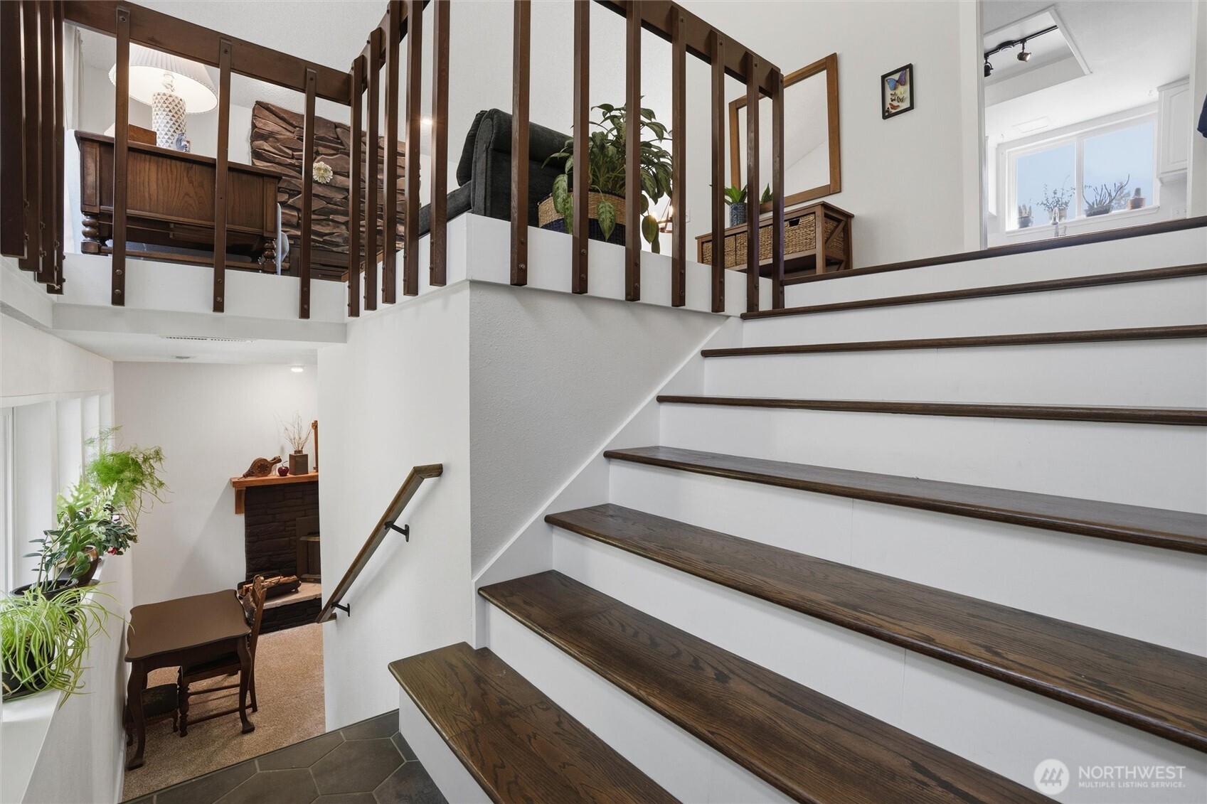 2065 Opdal Road East Port Orchard, WA 98366 - Photo 4 of 40 a view of staircase with lots of frames on wall and a potted plant
