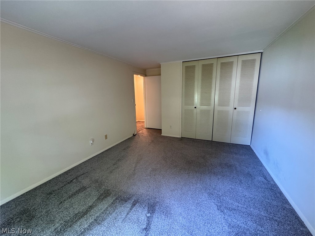 7294 Fox Mill Road, Unit 19D Mentor, OH 44060 - Photo 19 of 27 Spacious room featuring neutral wall paint, gray carpeting, and white baseboards