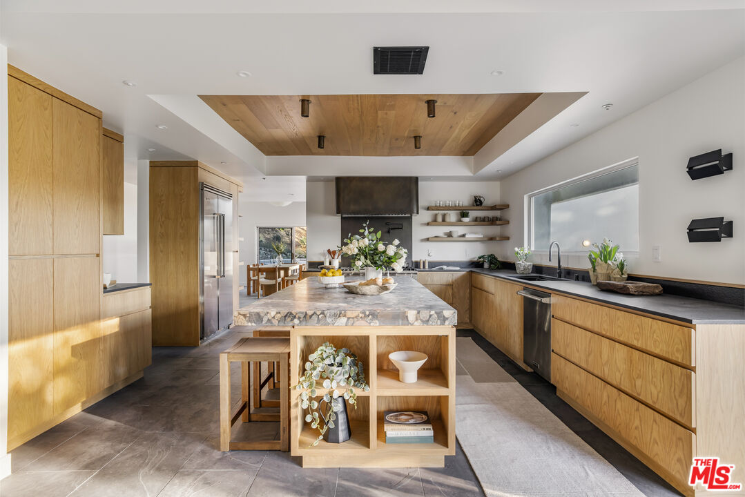 20711 Hillside Drive Topanga, CA 90290 - Photo 12 of 41 a kitchen with a table and chairs in it
