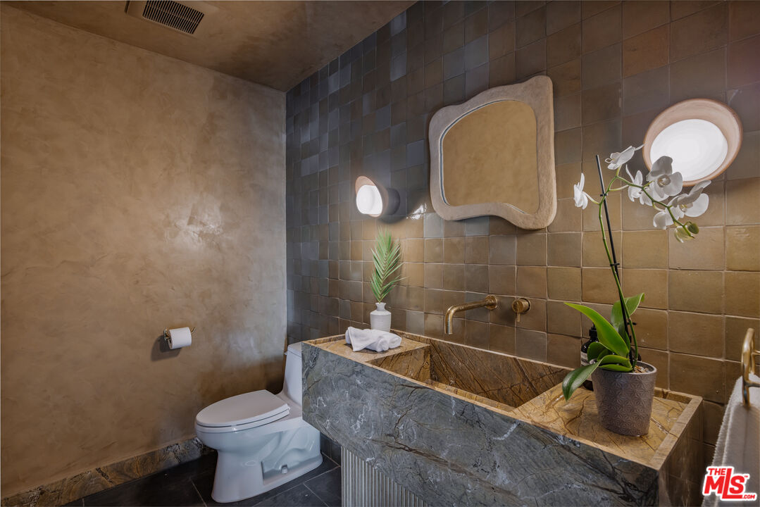 20711 Hillside Drive Topanga, CA 90290 - Photo 14 of 41 a bathroom with a granite countertop sink and a mirror