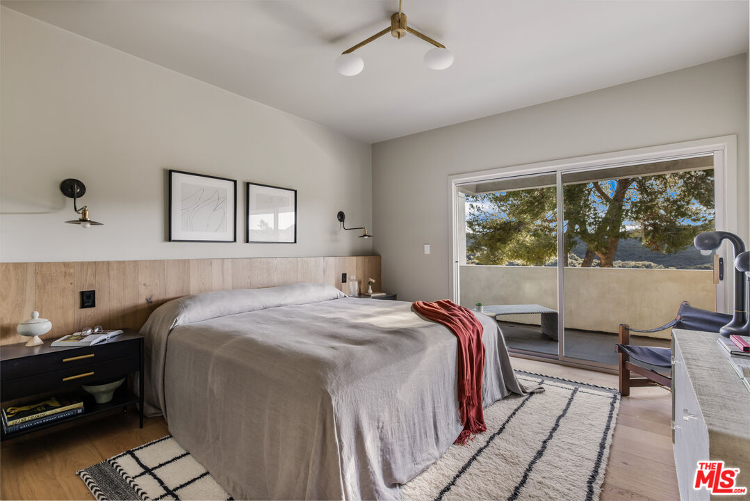 20711 Hillside Drive Topanga, CA 90290 - Photo 22 of 41 a bedroom with a large bed and a window