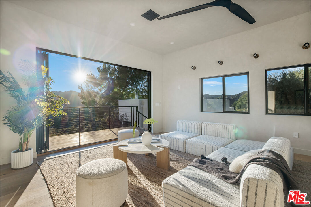 20711 Hillside Drive Topanga, CA 90290 - Photo 26 of 41 a living room with furniture and a large window