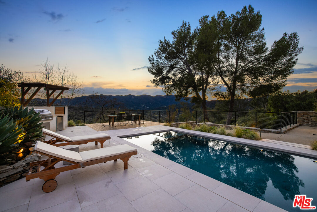 20711 Hillside Drive Topanga, CA 90290 - Photo 38 of 41 a view of a terrace with chairs and wooden fence
