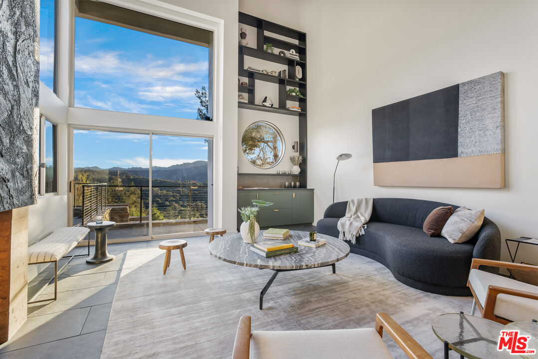 20711 Hillside Drive Topanga, CA 90290 - Photo 6 of 41 a living room with furniture and a floor to ceiling window