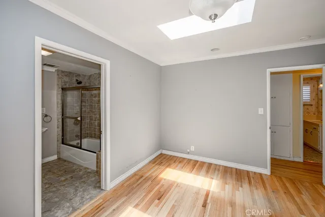a view of a room with wooden floor and a sink