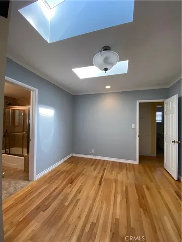 a view of a room with a dishwasher and wooden floor
