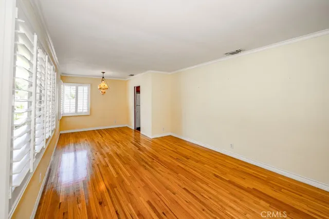a view of an empty room and wooden floor