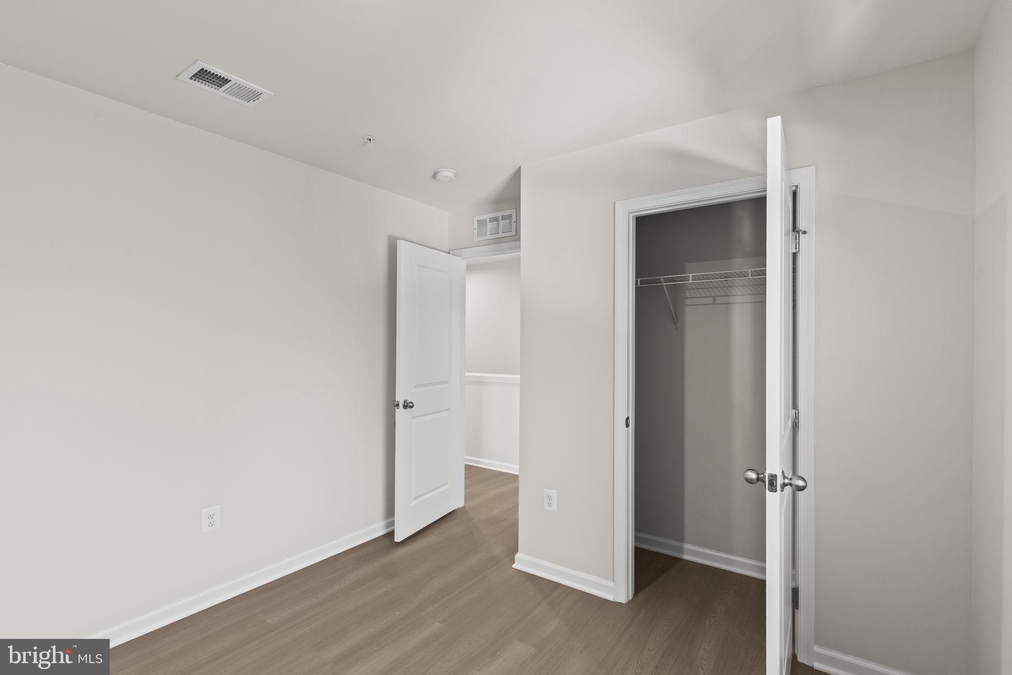 5404 Vergo Road Capitol Heights, MD 20743 - Photo 25 of 36 a view of an empty room with wooden floor and closet