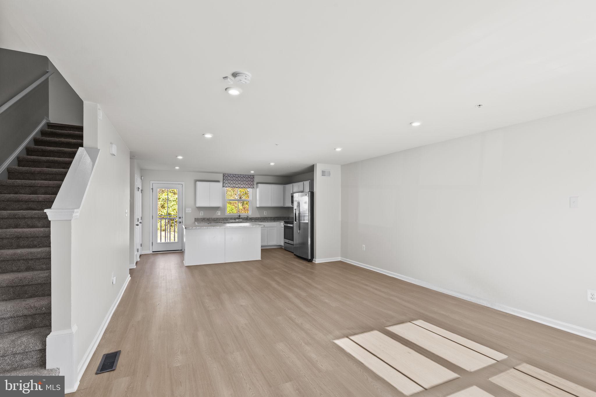 5404 Vergo Road Capitol Heights, MD 20743 - Photo 4 of 36 a view of a kitchen with a sink and dishwasher a refrigerator with wooden floor
