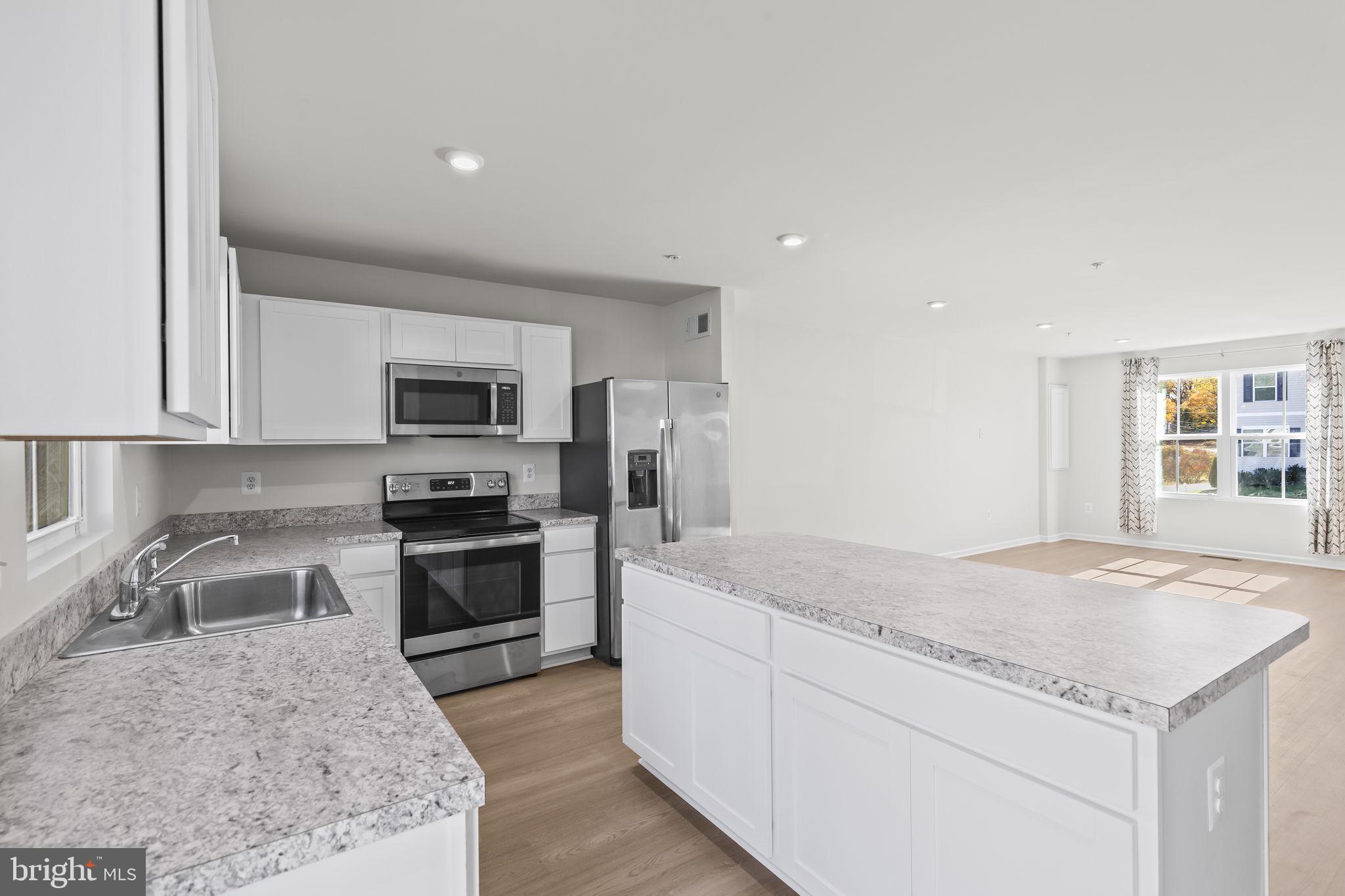 5404 Vergo Road Capitol Heights, MD 20743 - Photo 8 of 36 a kitchen with stainless steel appliances granite countertop a sink dishwasher stove and refrigerator