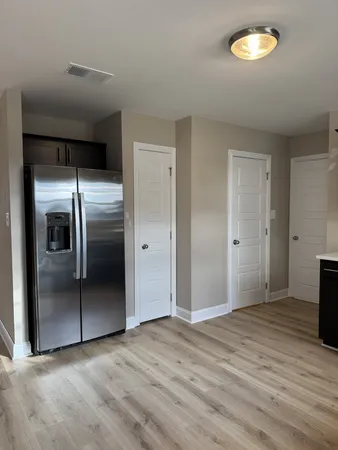 a view of an empty room with a kitchen