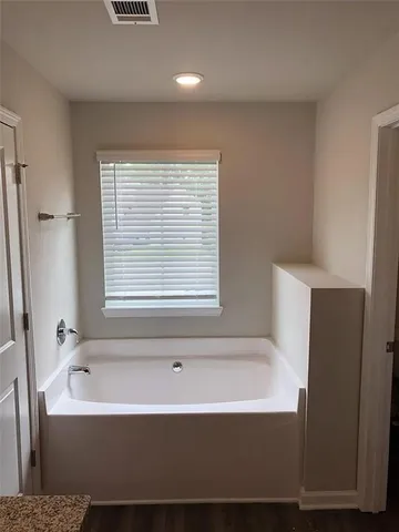 a bathroom with a bathtub and shower