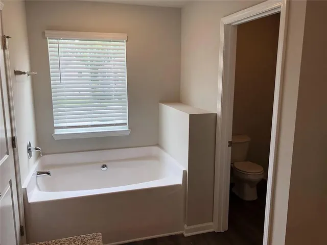a bathroom with a bathtub and a window