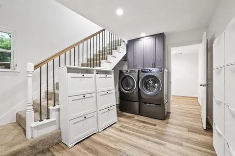 a view of a storage and utility room with washer and dryer