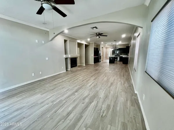 an empty room with closet and windows