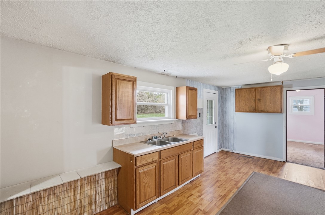 1166 West Sparrow Road Springfield, OH 45502 - Photo 19 of 40 This bright kitchen features ample cabinetry and a window overlooking the verdant outdoors.