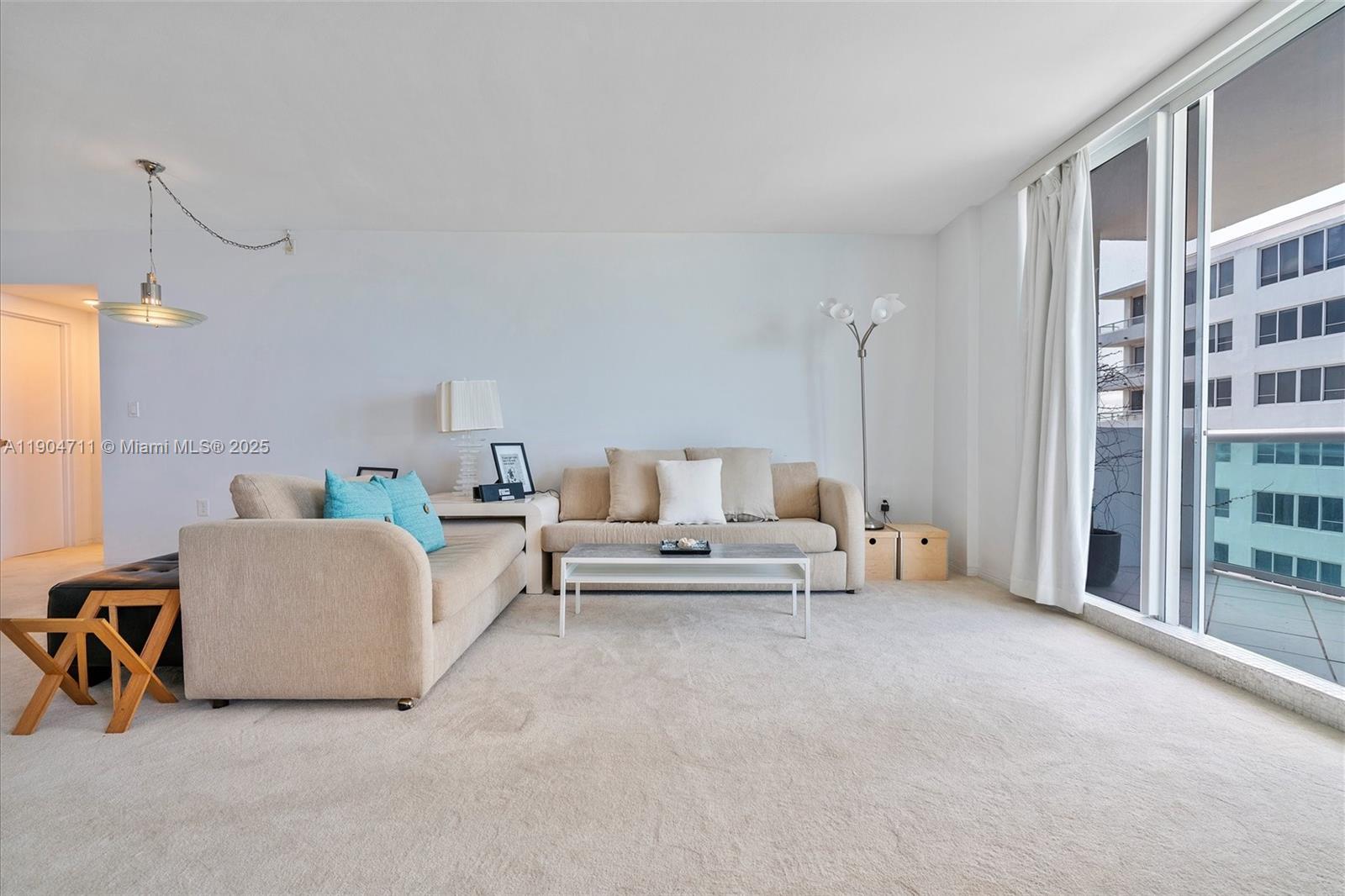 5001 Collins Avenue, Unit 11F Miami Beach, FL 33140 - Photo 13 of 43 a living room with furniture and a ceiling fan