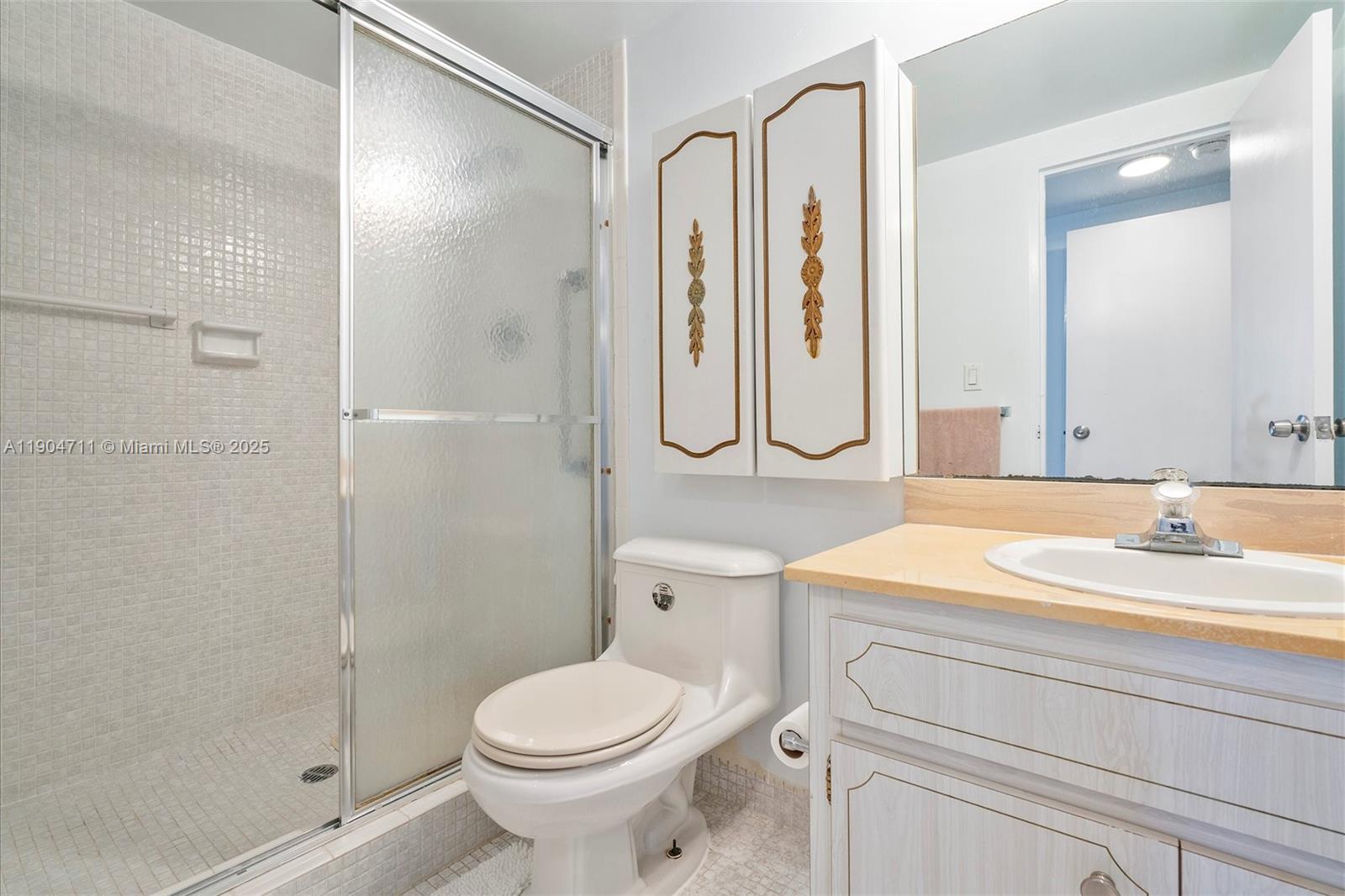 5001 Collins Avenue, Unit 11F Miami Beach, FL 33140 - Photo 15 of 43 a bathroom with a sink a toilet and shower