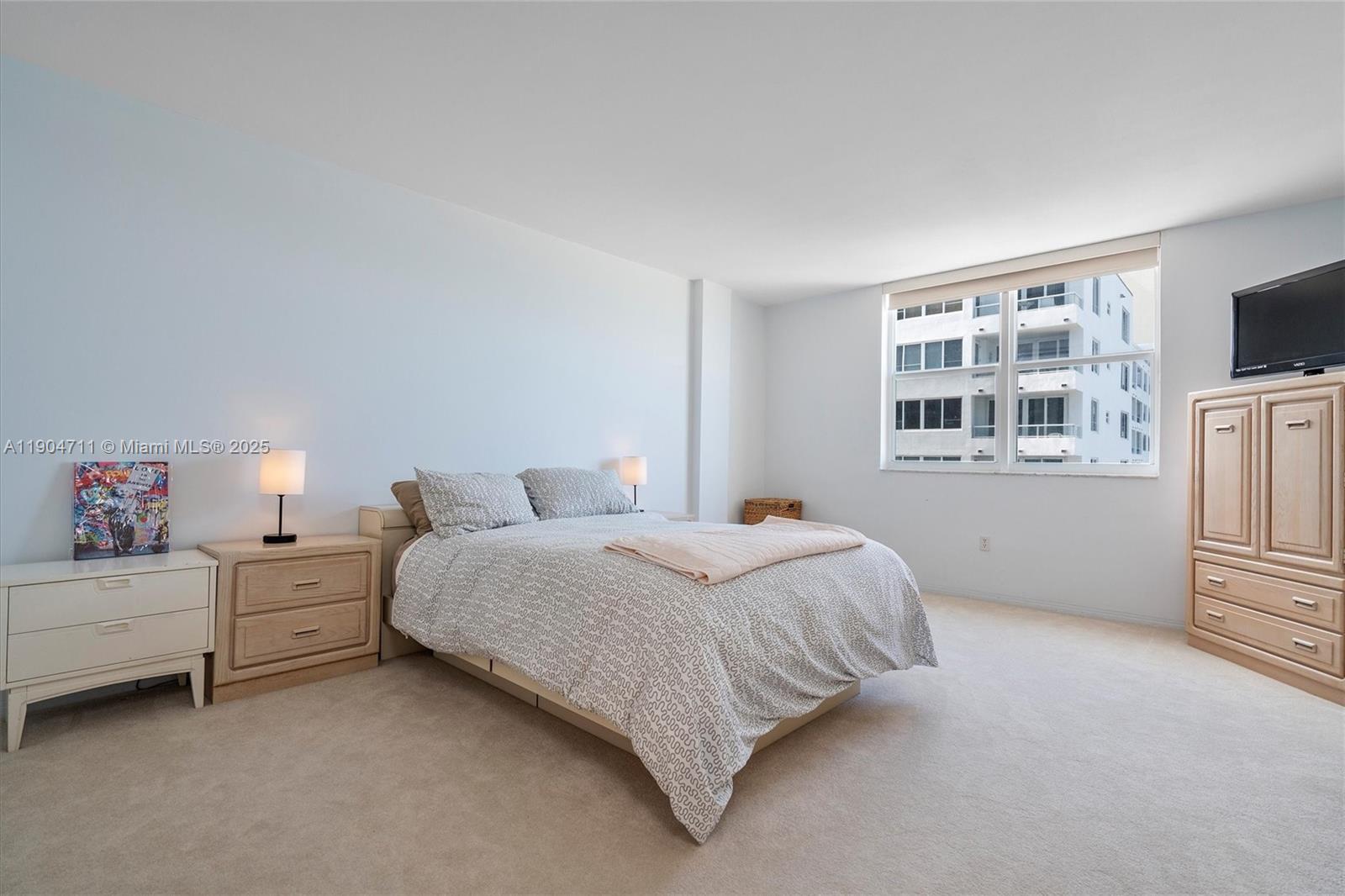 5001 Collins Avenue, Unit 11F Miami Beach, FL 33140 - Photo 17 of 43 a bedroom with a bed and a window