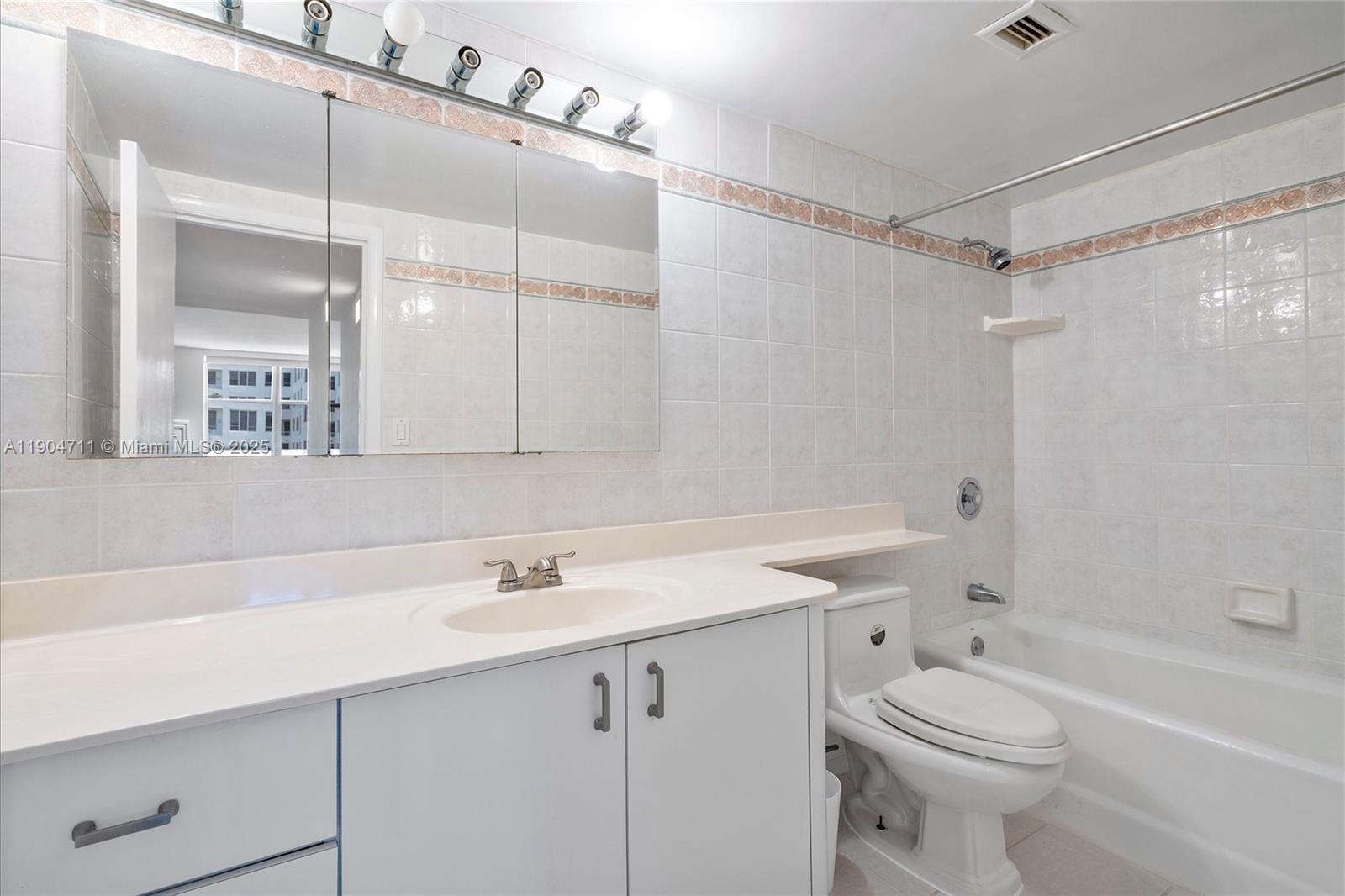 5001 Collins Avenue, Unit 11F Miami Beach, FL 33140 - Photo 22 of 43 a bathroom with a sink a toilet and shower