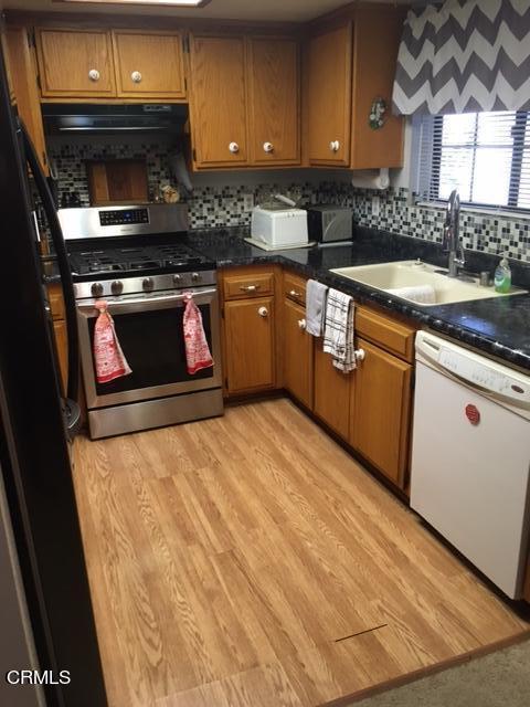 400 Burnham Road Oak View, CA 93022 - Photo 2 of 9 a kitchen with stainless steel appliances granite countertop a stove a sink and a microwave