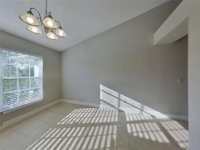 a view of wooden floor and chandelier in a room