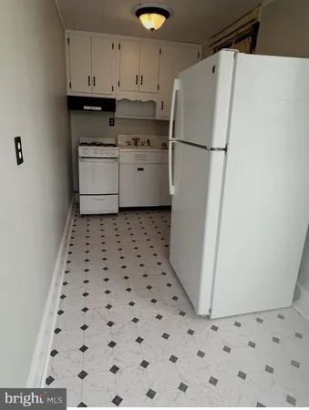 a white refrigerator freezer sitting inside of a kitchen