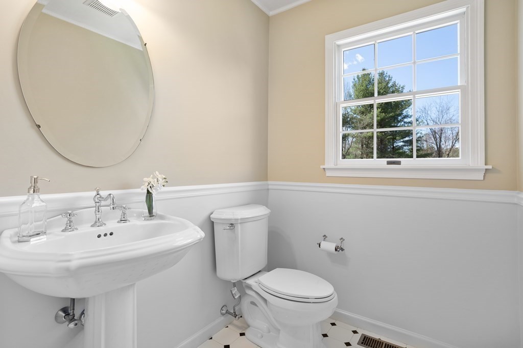 104 Nourse Road Bolton, MA 01740 - Photo 19 of 34 a bathroom with a sink a toilet and a mirror