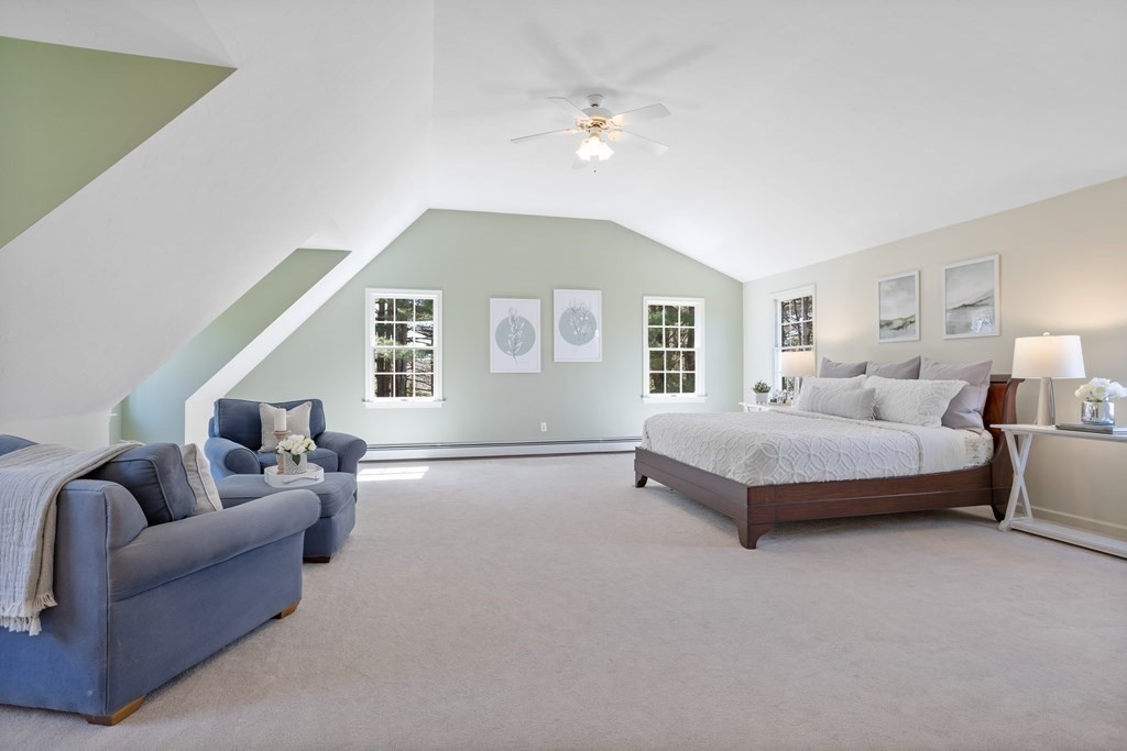 104 Nourse Road Bolton, MA 01740 - Photo 21 of 34 a spacious bedroom with a bed a couch and a large window