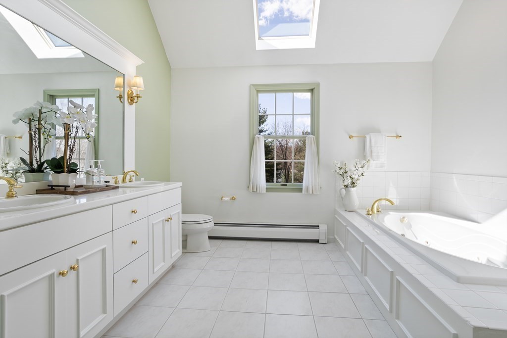104 Nourse Road Bolton, MA 01740 - Photo 23 of 34 a bathroom with a tub sink and a window