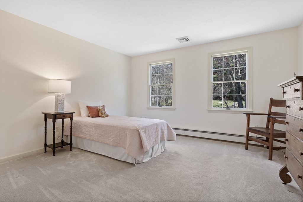 104 Nourse Road Bolton, MA 01740 - Photo 26 of 34 a spacious bedroom with a bed and a window