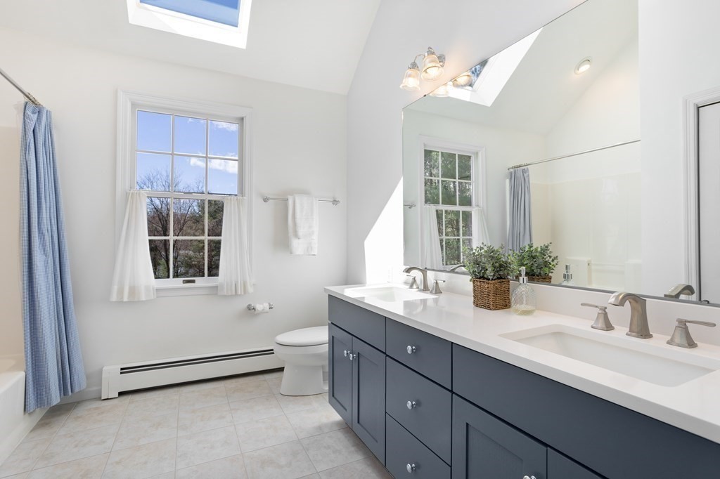 104 Nourse Road Bolton, MA 01740 - Photo 29 of 34 a bathroom with a double vanity sink toilet and shower