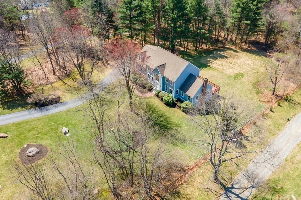 104 Nourse Road Bolton, MA 01740 - Photo 32 of 34 a view of a yard with plants and large trees