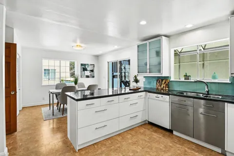 a kitchen with a stove and a wooden floors