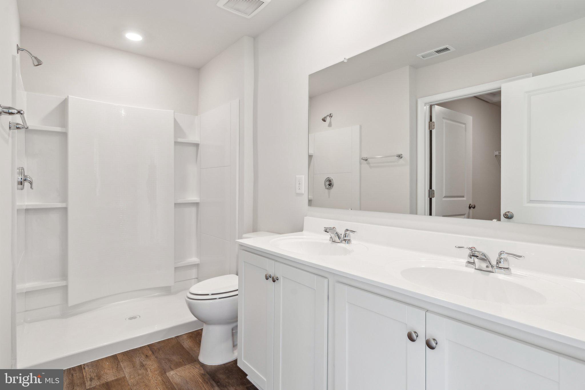 124 Parkland Road Greensboro, MD 21639 - Photo 13 of 20 a bathroom with a sink a toilet and a large mirror