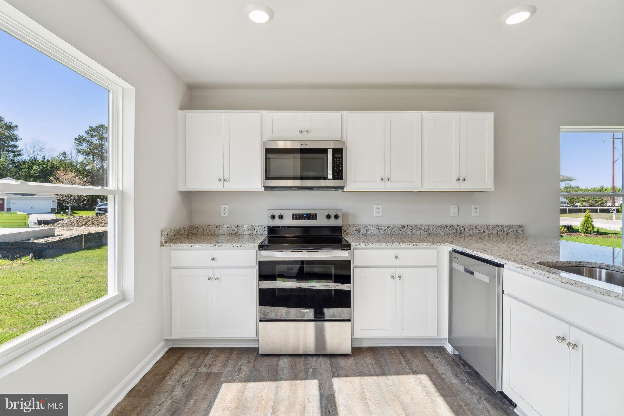 124 Parkland Road Greensboro, MD 21639 - Photo 4 of 20 a kitchen with stainless steel appliances granite countertop a stove a sink and a microwave