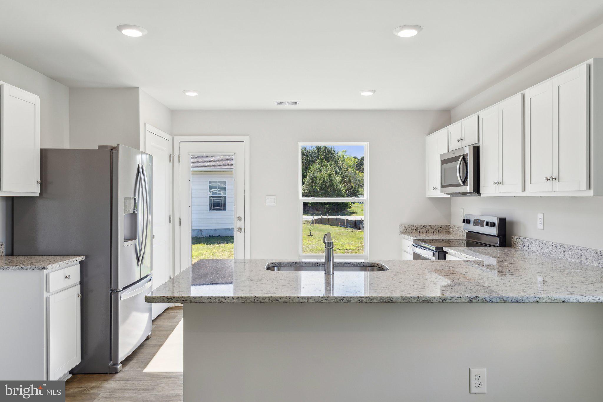 124 Parkland Road Greensboro, MD 21639 - Photo 5 of 20 a kitchen with stainless steel appliances granite countertop a sink a stove and a refrigerator