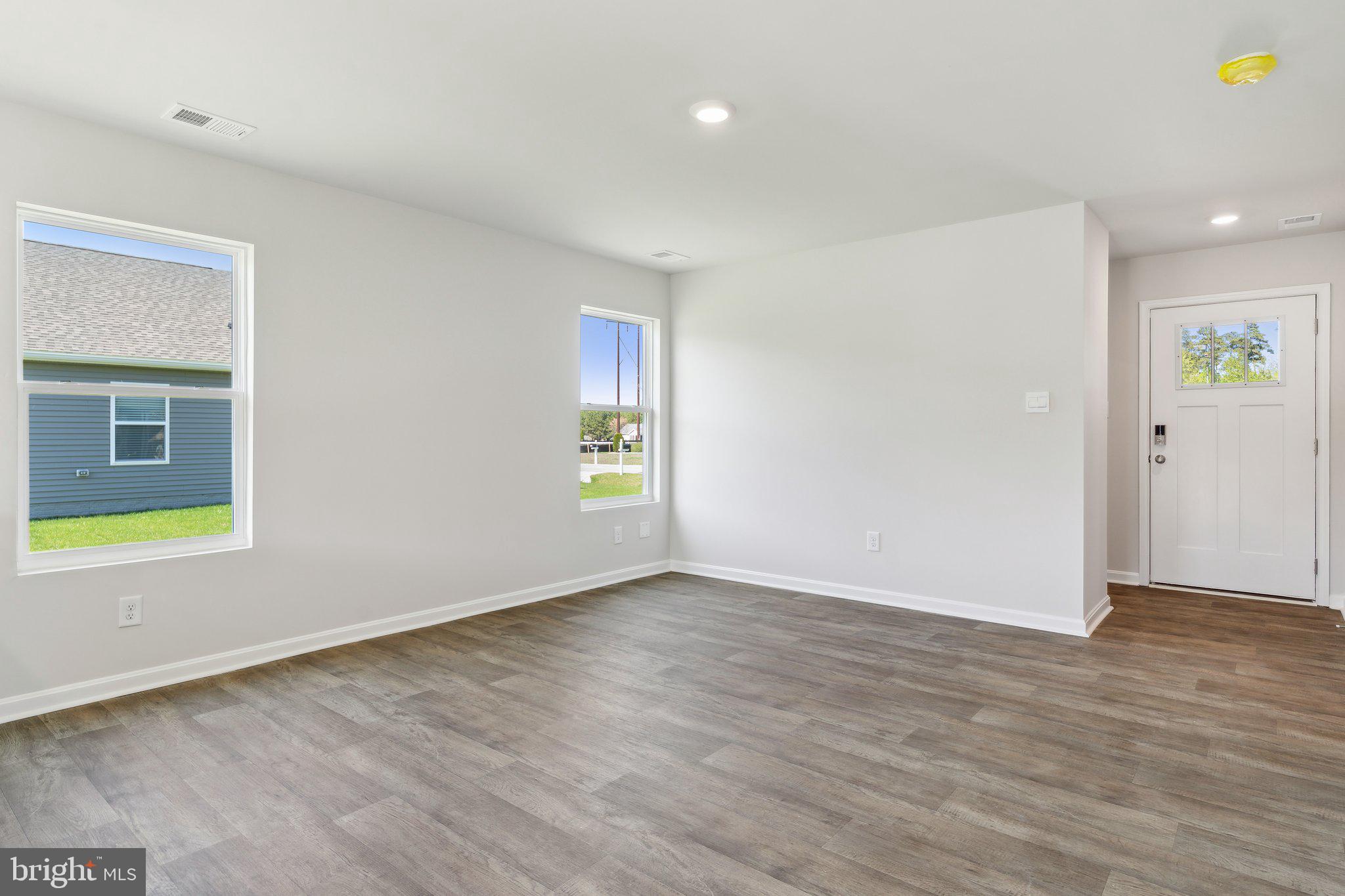 124 Parkland Road Greensboro, MD 21639 - Photo 6 of 20 an empty room with wooden floor and windows