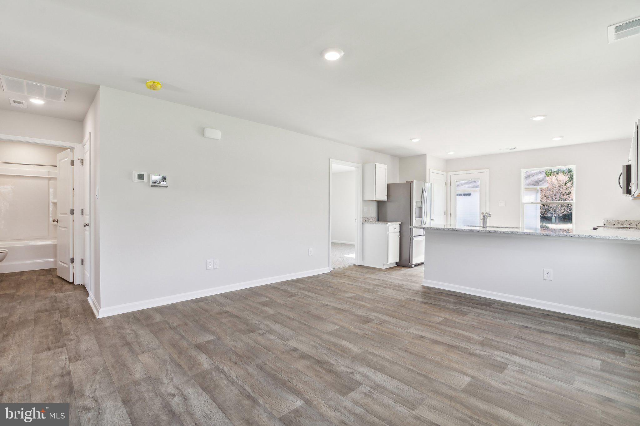 124 Parkland Road Greensboro, MD 21639 - Photo 8 of 20 a view of empty room with wooden floor