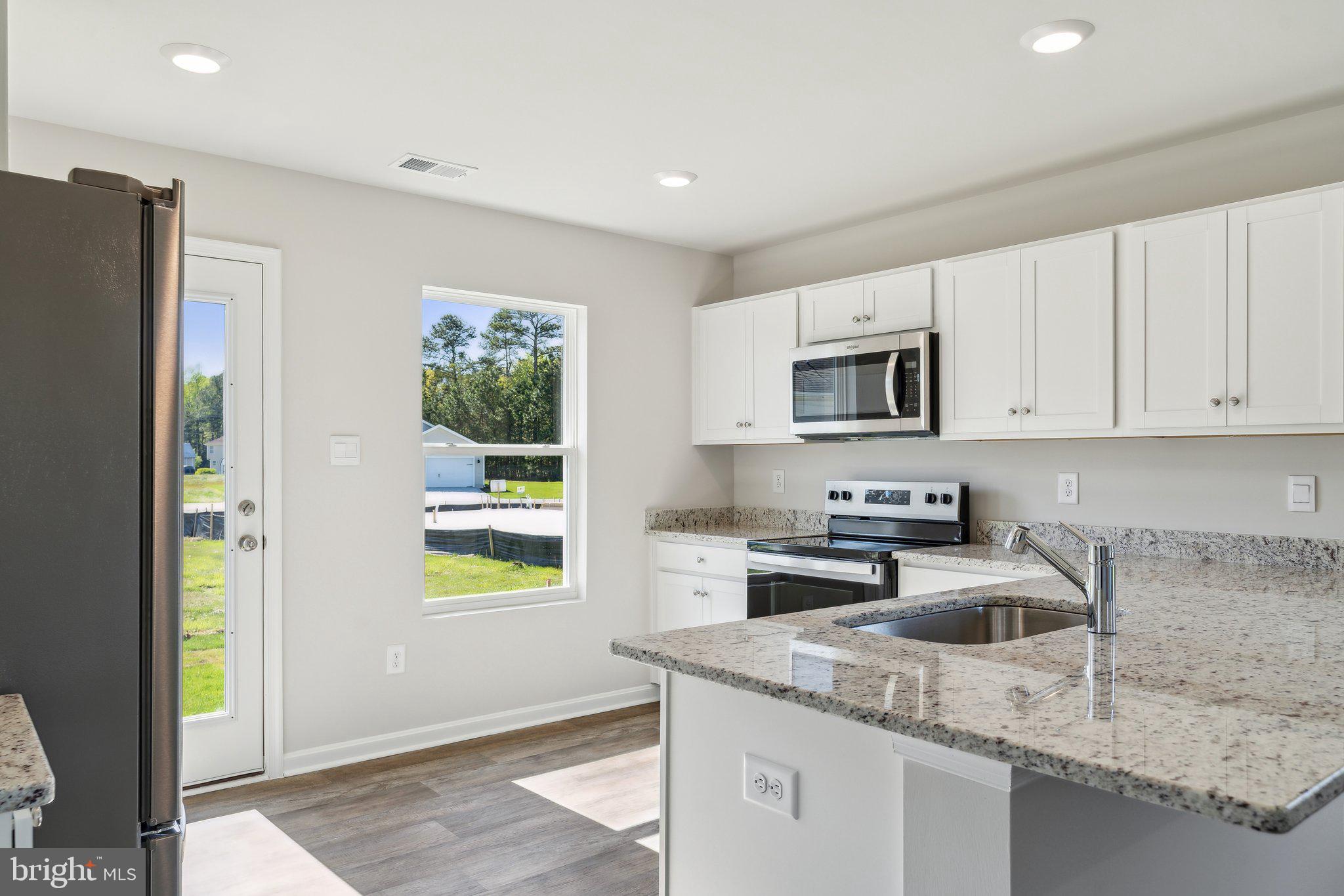 124 Parkland Road Greensboro, MD 21639 - Photo 9 of 20 a kitchen with stainless steel appliances granite countertop a refrigerator sink and microwave