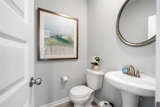 a white toilet sitting next to a bathroom sink