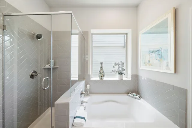 a bathroom with a bathtub and a shower