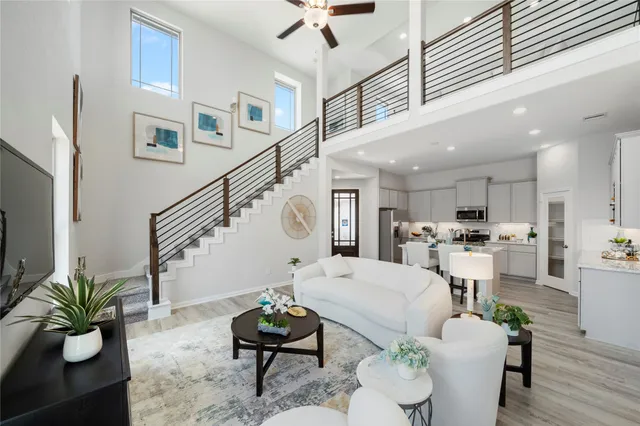 a living room with furniture chandelier and couches