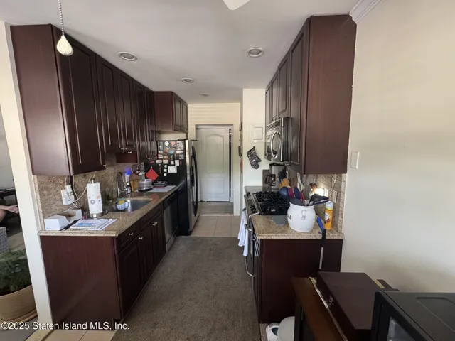 a kitchen with sink cabinets and appliances