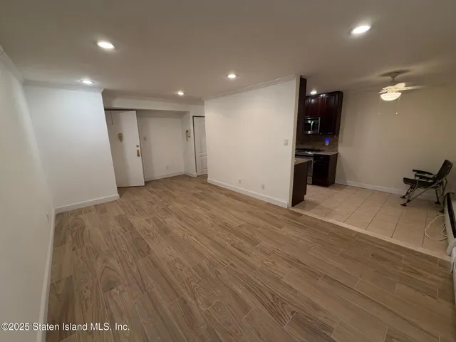 a view of a room with wooden floor