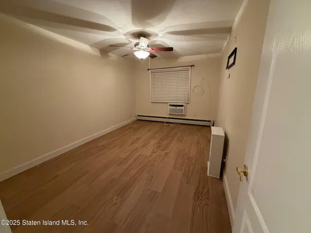 a view of a room with wooden floor and chandelier