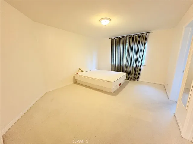 a bed room with a bed and a night stand